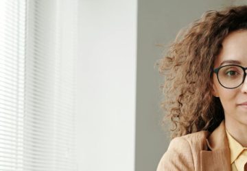 Junge Frau mit Brille blickt ruhig in die Kamera – symbolisch für Sicherheit, Vertrauen und gute Vorsorgeberatung.